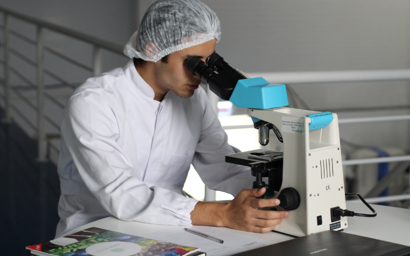 Person using microscope